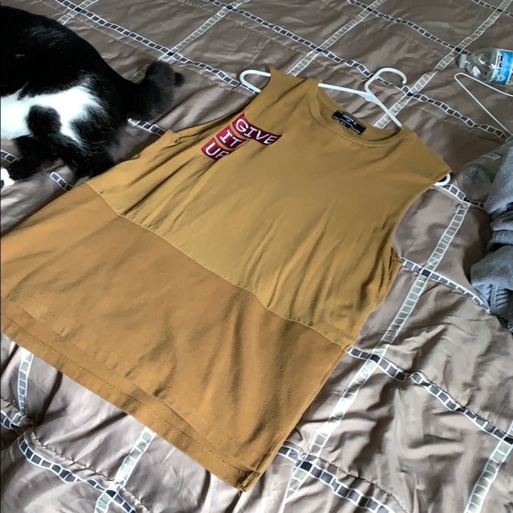 A brownish shirt says